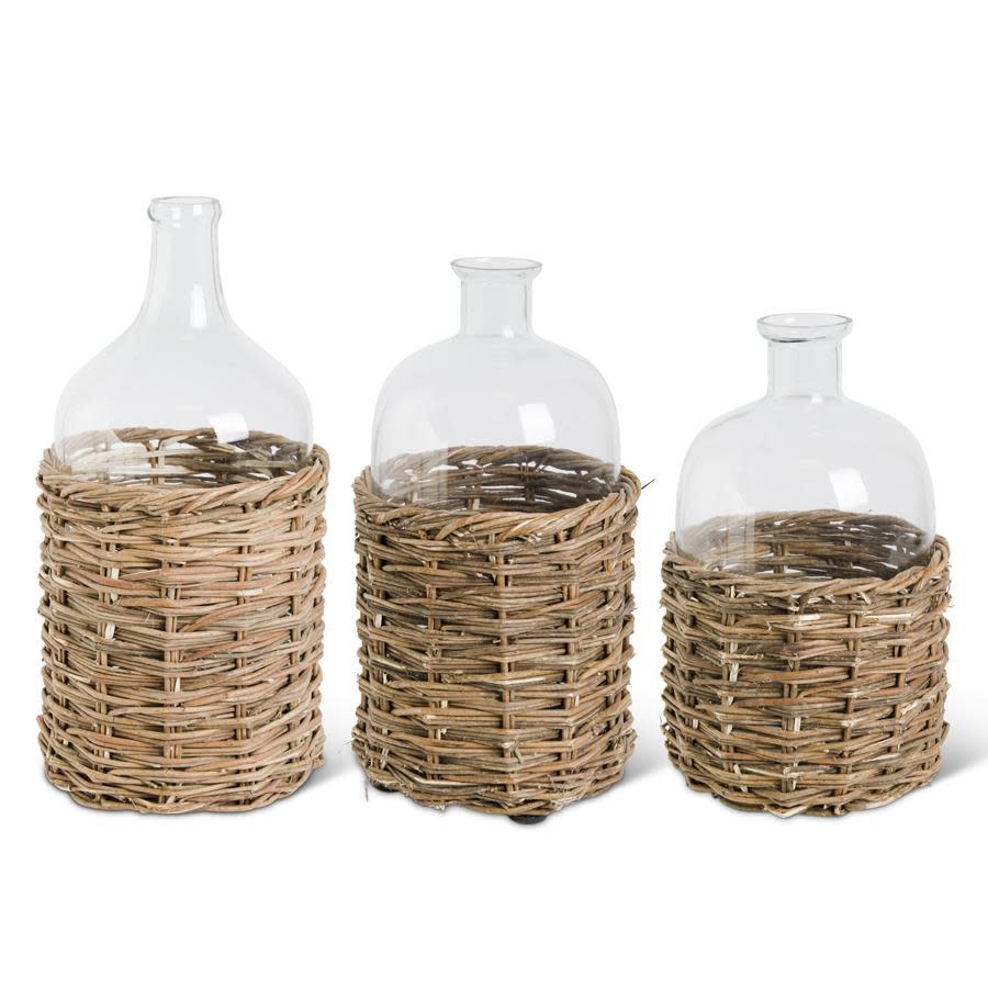 Large Clear Glass Bottles in Woven Rattan Basket